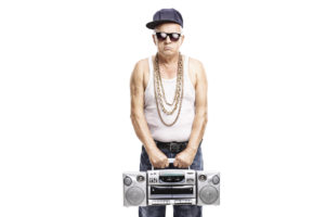 Mature rapper holding a ghetto blaster and looking at the camera isolated on white background