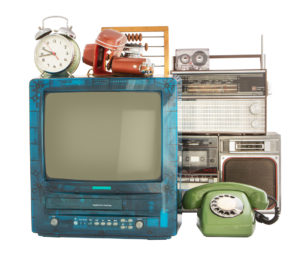 Old household items: TV, VCR, radio, camera, alarm, phone, recorder, abacus. Old household items isolated on white background.